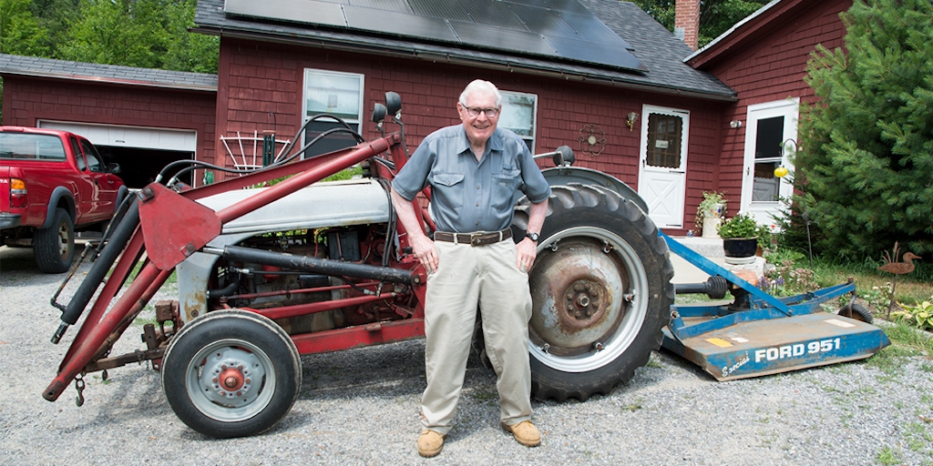 New England Forestry Foundation donor Ben Pratt stands in front of his tractor
